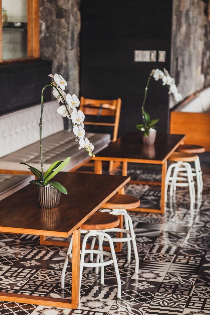 Modern wooden furniture in cafe on floor with black and white ornament tile two chairs table.jpg